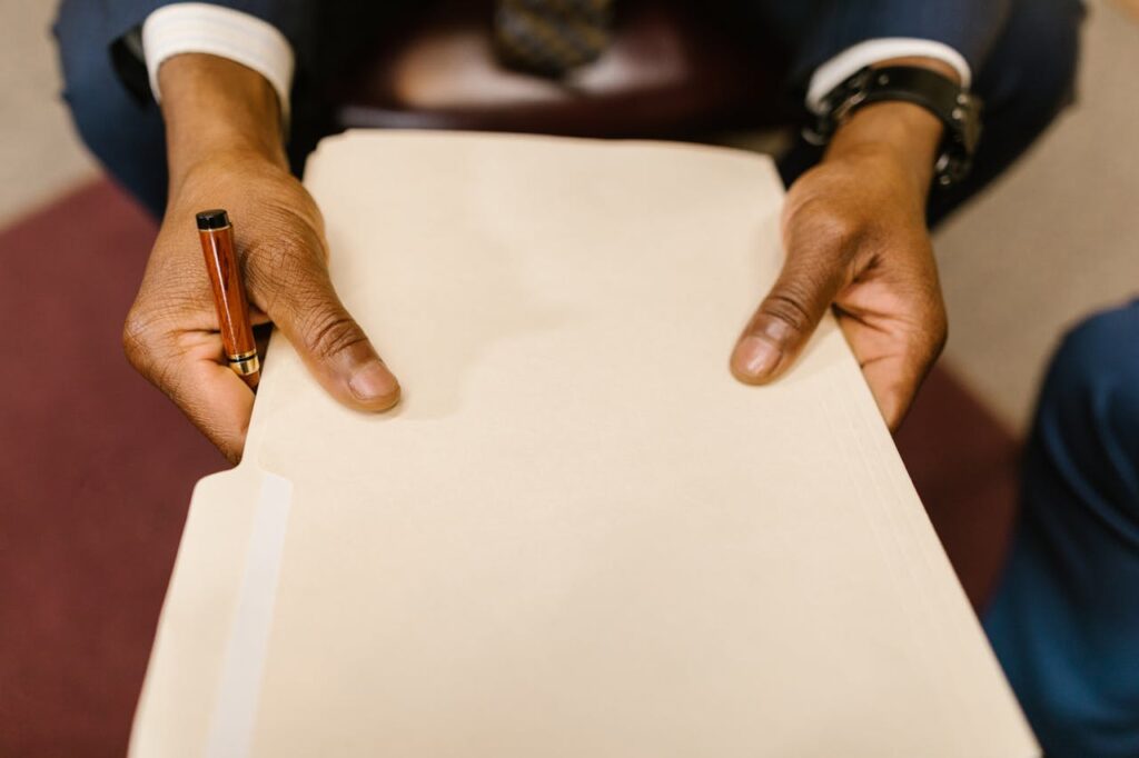 pexels-photo-7841479 Close-Up Shot of a Person Holding a Document